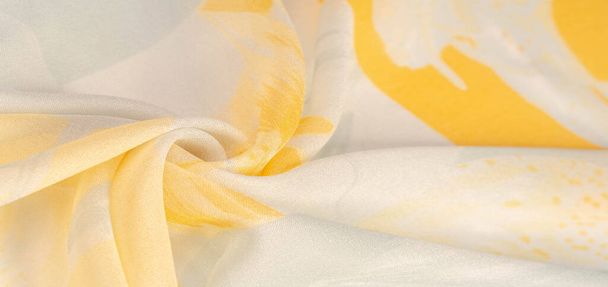 Texture, background, pattern, silk fabric, yellow flowers on a gray background. Your projectors will be pacified, this delicate fabric in pastel colors will cause decks and fantasies - Photo, Image