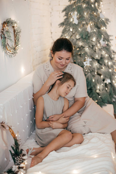 Petite fille mignonne et mère posant à l'intérieur de Noël
   - Photo, image
