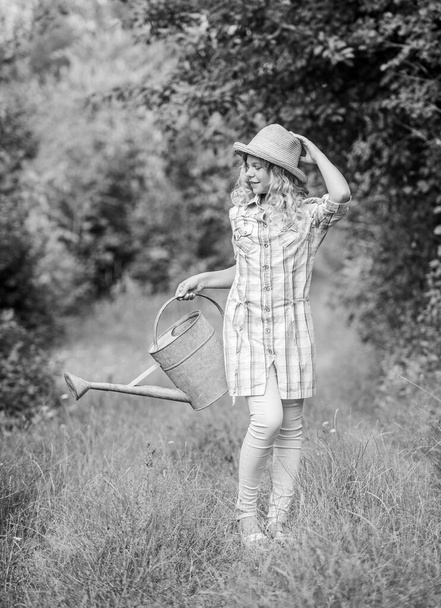 kid gardening. earth day. environment ecology. nature protection. little girl farmer care plants. farming and agriculture. spring country side village. summer season. small girl with watering can - Фото, изображение