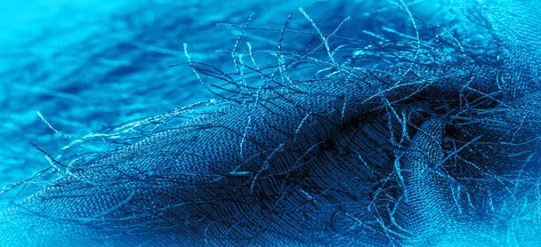 Фоновая текстура, декоративный орнамент, синяя шелковая ткань, тканые нити на ткани, пушистый эффект, ощущение, внешний вид или текстура поверхности - Фото, изображение