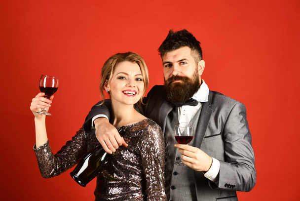 Lady and gentleman celebrating with merlot. Woman in sparkling dress - Foto, immagini