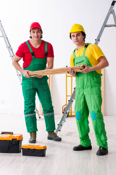 Two workers contractors working indoors - Фото, изображение