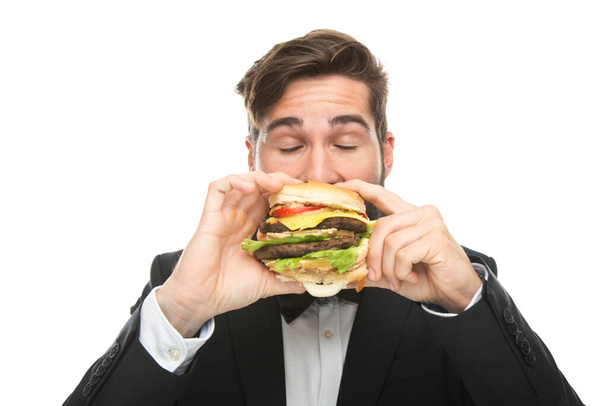 fiatal üzletember hamburgerrel és szendvicsgel - Fotó, kép