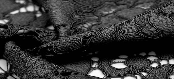 Textuur, achtergrond, patroon, zwarte kant stof, delicate reliëf kant stof, geschulpte op beide randen. Geschikt voor uw projecten, ontwerp, enz.. - Foto, afbeelding