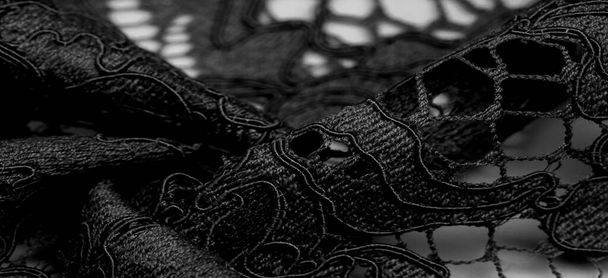 Textuur, achtergrond, patroon, zwarte kant stof, delicate reliëf kant stof, geschulpte op beide randen. Geschikt voor uw projecten, ontwerp, enz.. - Foto, afbeelding
