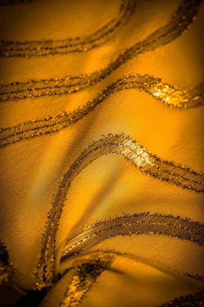 ornament of the decor, the fabric is transparent mustard yellow with brightly congenital stripes, the material allowing the light to pass through it so that the objects behind are clearly visible - Photo, Image