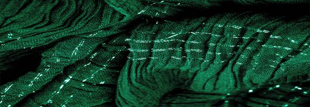 La texture de l'image de fond la couleur du tissu sous l'eau, tissu ondulé vert-bleu, tissu avec plis parallèles ou diagonaux avec plis dentelés ; produits d'un tel tissu. - Photo, image