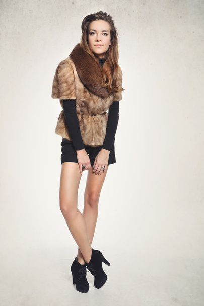 Fashion model in a fashionable vest with fur - Foto, afbeelding