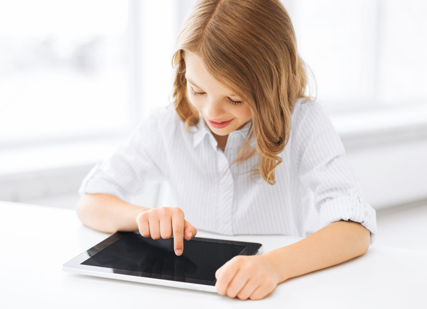 Smiling little girl with tablet pc at school - Foto, Imagem