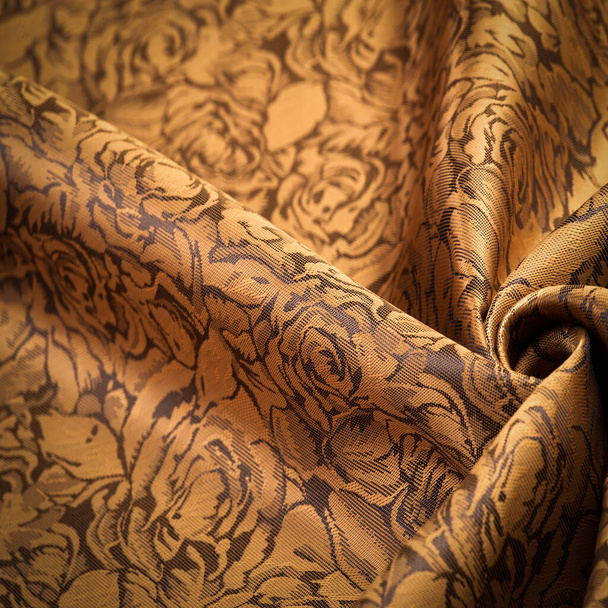 embossed pattern, composite textile, silk fabric of yellow, gold color, with a floral pattern, unusually pleasant visual sensations: slippery, coolness, softness; beautiful appearance, unique shine; - Photo, Image
