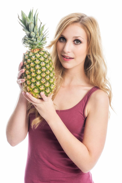 a woman holds an ananas - 写真・画像