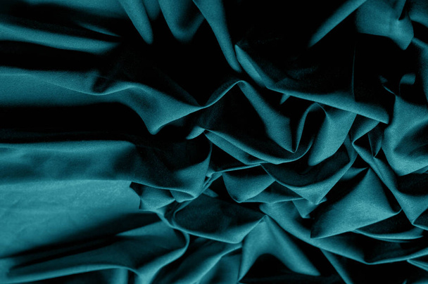 Textured, background, pattern, turquoise fabric. This is an unusual fabric that has an elegant appearance with a rich and coarse texture. It is tightly knit with designs built into the fabric itself - Foto, imagen