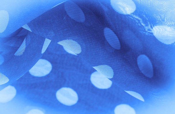 Текстура тла, декоративний орнамент, синя шовкова тканина, круглі крапки на тканині, які мають форму або приблизно нагадують коло або циліндр
. - Фото, зображення