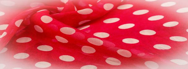 Background texture, decorative ornament, red polka dot fabric in white polka dots, round dots on fabric, shaped like or approximately like a circle or cylinder. - Photo, Image