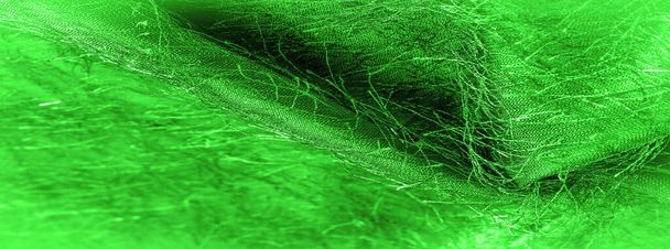 Фоновая текстура, декоративный орнамент, зеленая шелковая ткань, тканые нити на ткани, пушистый эффект, ощущение, внешний вид или текстура поверхности - Фото, изображение