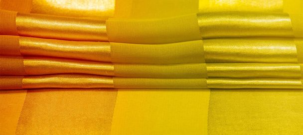 Texture, background, yellow silk striped fabric with a metallic sheen. If you have a bad mood, this fabric will lift it to unprecedented heights. Your project will be successful. - Photo, Image