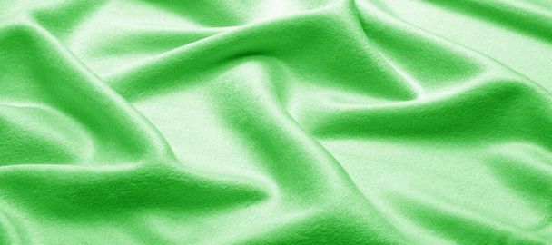Tekstuuri, tausta, kuvio. Kangas lämmin villa on vihreä, paksu raskaalla painolla, tämä on erinomainen valinta suunnittelullesi, jolloin projektin mahdollisuudet ovat äärettömät.
. - Valokuva, kuva