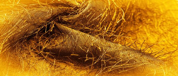 Textura de fondo, adorno decorativo, tela de seda de oro amarillo, hilos tejidos en la tela, efecto esponjoso, sensación, apariencia o textura de una superficie o sustancia - Foto, Imagen