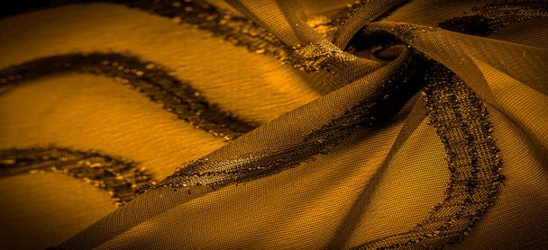 ornamento da decoração, o tecido é amarelo mostarda transparente com listras brilhantemente congênitas, o material que permite que a luz passe por ele para que os objetos por trás sejam claramente visíveis
 - Foto, Imagem