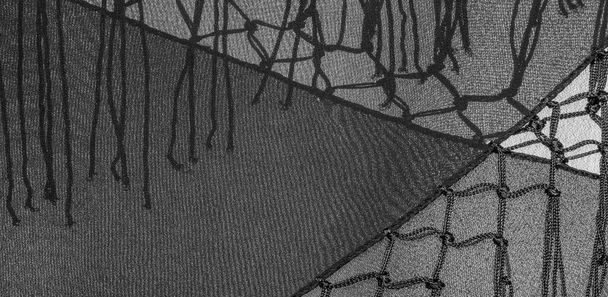 Фон текстуры шелковой ткани. Это натуральный черный шарф, этот красивый нейлоновый сатин из района с прозрачной рукой и прекрасным блеском идеально подходит для ваших проектов.. - Фото, изображение