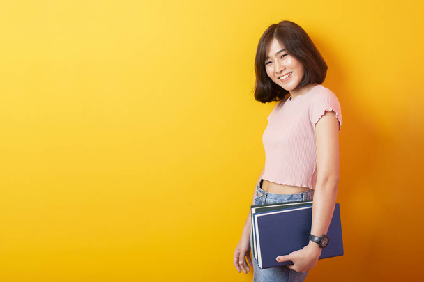 Beautiful asian woman University student happy on yellow background  - Photo, image