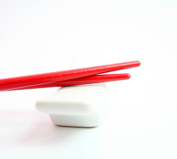 red plastic chopsticks isolated on white background - Foto, Imagem