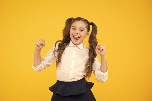 Celebrate knowledge day. Girl pupil on yellow background. Back to school. Student little kid. Emotional school girl. Successful graduation. Happy childrens day. Positive vibes. School life concept - Foto, Bild