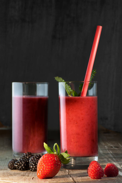Healthy red smoothie on rustic wooden table - 写真・画像