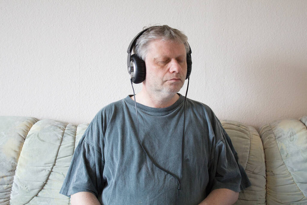 Man with headphones and closed eyes - Photo, Image