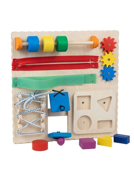 Wooden toy busybord for little kids up to 1 year: multi-colored doors with a latch, wooden maze, zipper for clothes fasteners,lacing,geometric shapes (square, circle, rectangle , triangle, gears, educational toy for for the development of children - Photo, Image