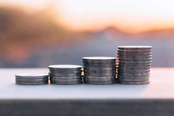 Close up money stack coin under sunset background. Business finance growth concept. - Fotó, kép