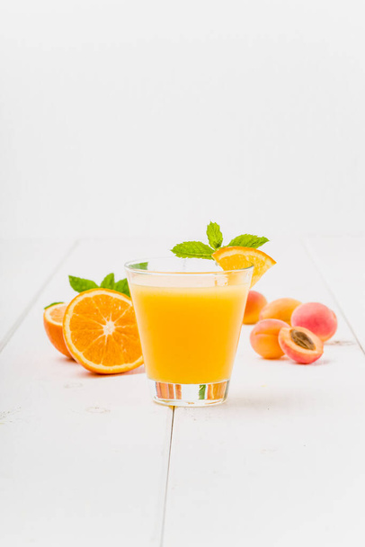 Orange apricot juice with fresh mint - Fotó, kép