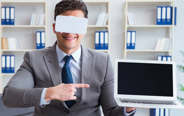 Businessman in virtual reality VR glasses meditating at desk top - Photo, Image