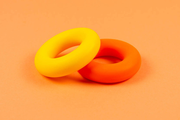 Yellow and orange expander on orange  background.  Copy space. - Фото, зображення