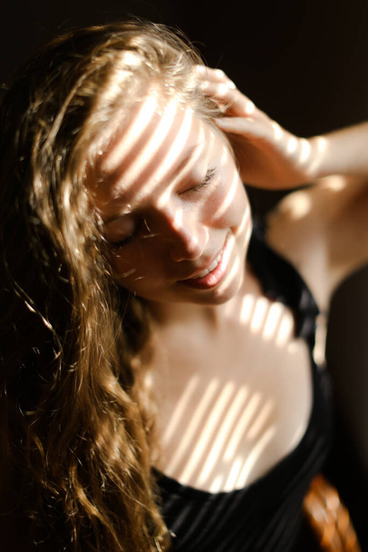 Close up portrait of young woman with striped shadows. - Zdjęcie, obraz