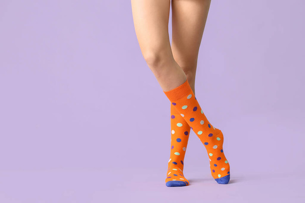 Legs of young woman in socks on color background - Photo, Image