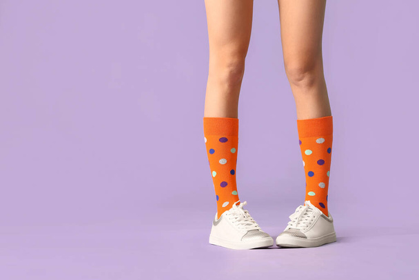 Beine der jungen Frau in Socken und Schuhen auf farbigem Hintergrund - Foto, Bild