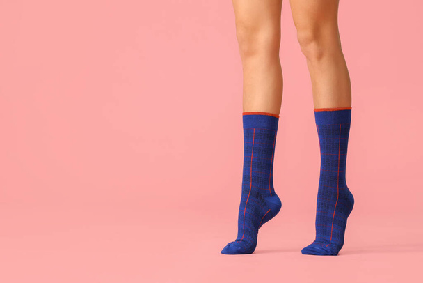 Legs of young woman in socks on color background - Photo, Image