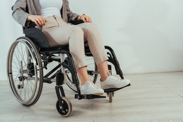 Cropped view of disabled woman on wheelchair on white background - Foto, Bild