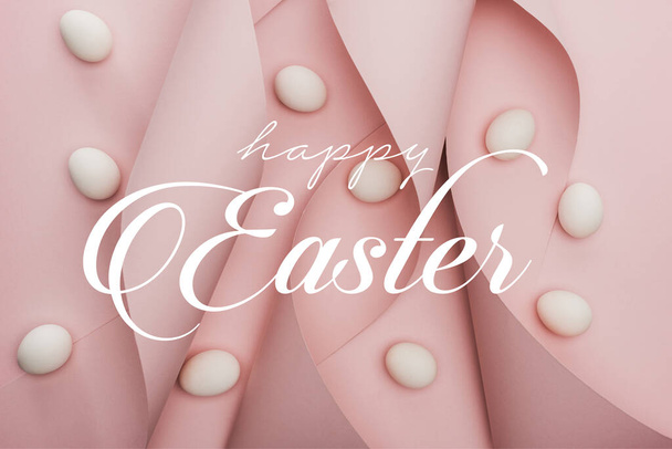 top view of chicken eggs in spiral paper pink swirls with happy Easter illustration - Φωτογραφία, εικόνα