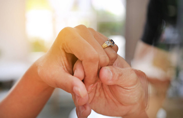 Hands of groom putting wedding ring for Bride. Close up. - Foto, imagen