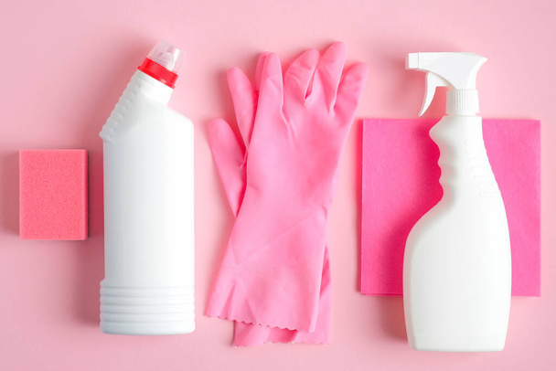 Set of cleaning supplies on pink background. House cleaning service and housekeeping concept. Flat lay, top view. - Fotografie, Obrázek