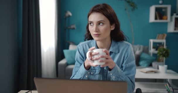 Confident woman having coffee break while working on laptop - Záběry, video