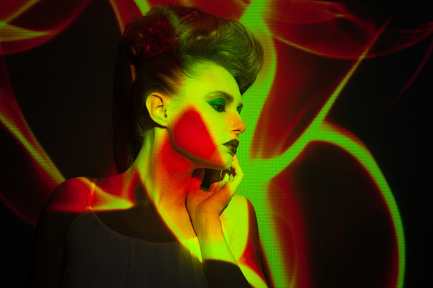 Creative portrait, fashion woman with color image on her face - 写真・画像