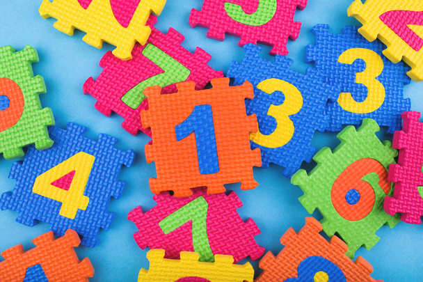 Colorful kids numbers toys on blue background. Education concept. Creative concept. Flat lay, copy space, top view. - Fotografie, Obrázek