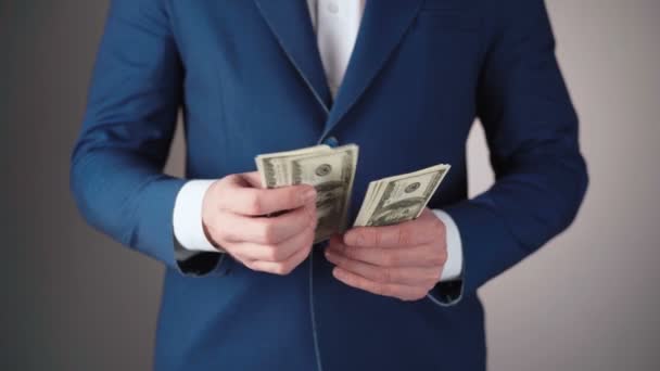 青いジャケットのビジネスマンのビデオカウントドル - 映像、動画