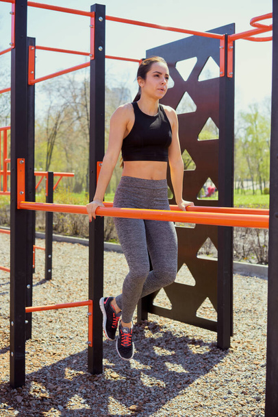 young woman doing exercises outdoor - Fotó, kép