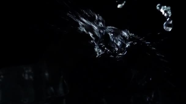 Falling of cubes of ice on a black background. Slow motion. - Metraje, vídeo
