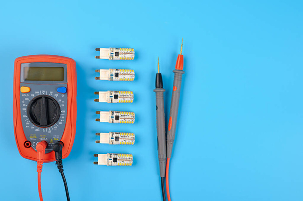 LED lamps with an electrician tool on a blue background. - Photo, Image