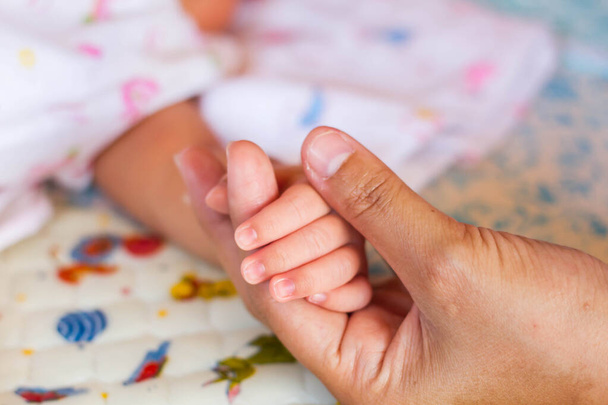 little hand of sleeping baby newborn close up - Foto, afbeelding